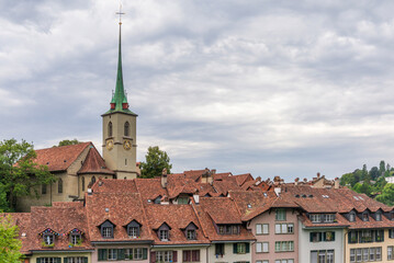 Aerial view of Medieval Town, Church and old houses rooftops in Bern, Switzerland, 16 Aug 2022