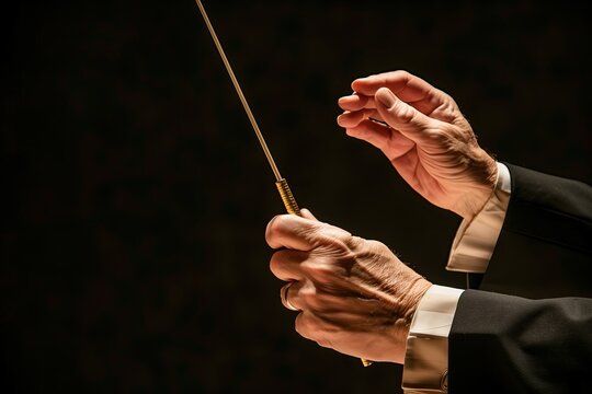 Orchestra conductor. Audience. Stage. Performance. Leading the symphony orchestra with a baton. Copy space. Conductor's stick. Gesture. A bandleader. Maestro. Classical music. A band director. Concert