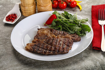 Grilled chuck roll steak with arugula