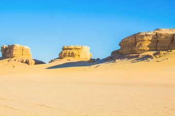 Abstract art shooting for Fayoum Rock Stone Desert, yellow sands and rocks, blue sky, photo is...