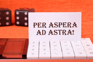 Per aspera as astra in English means through hardships to the stars on a white business card on a...