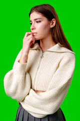 Young Woman Contemplating Deeply Against a Vibrant Green Background