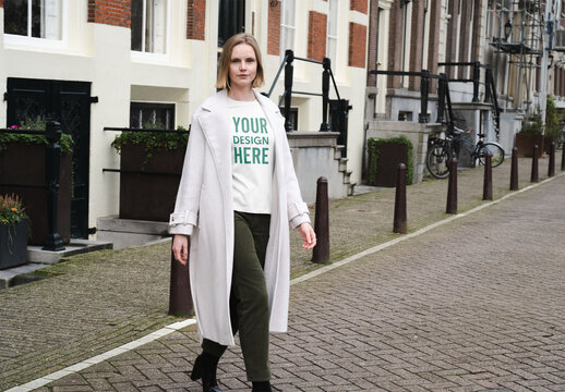 Mockup of woman in customizable sweatshirt on cobbles