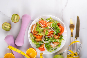 Balanced salad with fruit and fitness equipment
