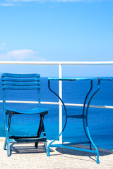 blue chair and table in greece in summer during holidays, vacation. 