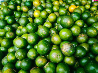 photography of close up texture background of pile of green orange fruit