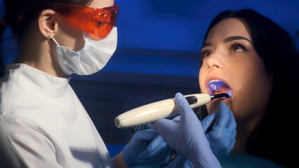 Young female dentist during work process, close-up of young woman's dental treatment. Concept of...