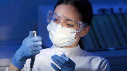 Portrait of a female dentist at work in dentistry in a white coat, busy with the work process....