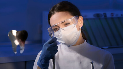 Portrait of a female dentist in the interior of a modern dental clinic at her workplace. The...