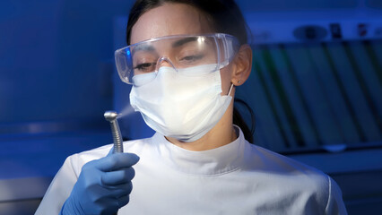 Portrait of a female dentist in the interior of a modern dental clinic at her workplace. The...