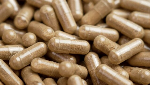 Herbal supplement capsules with herbal Fadogia Agrestis plant extract to increase male testosterone and sexual health. Rotation