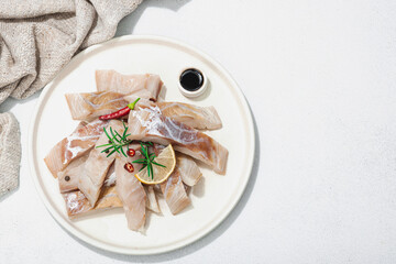 Raw pollock (Pollachius virens) fillet. Fresh fish for healthy food lifestyle. Spices and herbs