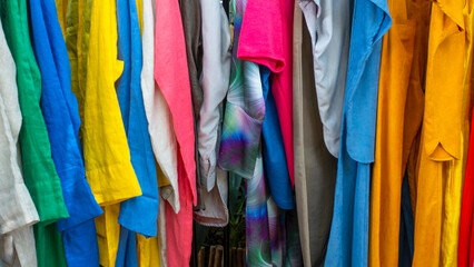 Bali MARCH 2024 - Brightly colored clothes on mannequins at a flea market in Bali, Indonesia

