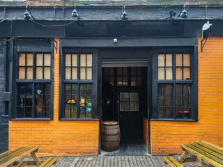 The black and orange exterior of a city bar