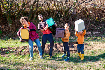 Funny family holding recycling bins. Eco family living concept.