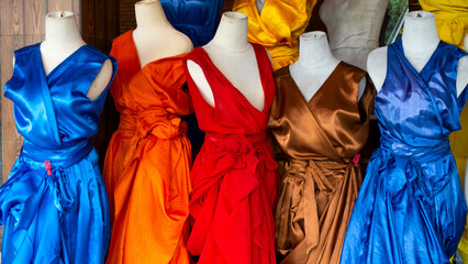 Bali MARCH 2024 - Brightly colored clothes on mannequins at a flea market in Bali, Indonesia

