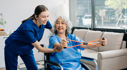 Physiotherapist helping elderly man patient stretching arm during exercise correct with dumbbell in...