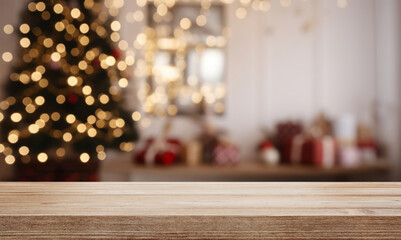 Empty wooden table over defocused christmas background with copy space