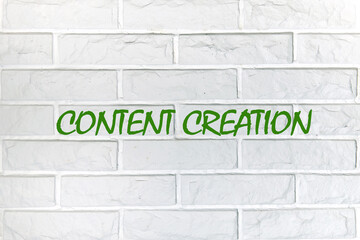 Business time for content creation concept. Concept words Content creation writing on the wall is made of white decorative bricks