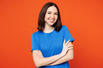 Young smiling cheerful fun cool happy woman she wears blue t-shirt casual clothes hold hands...