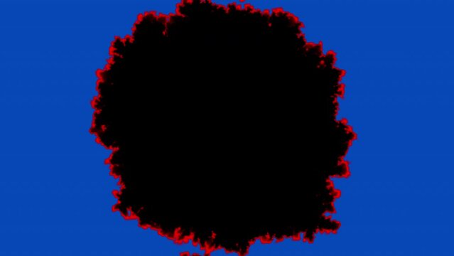 Paper burning from the center, video transition. Smoldering surface isolated on a blue chromakey