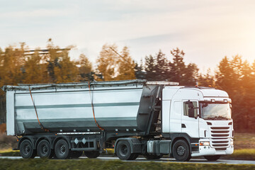 Heavy Dumper Truck Transporting Gravel Along the Highway