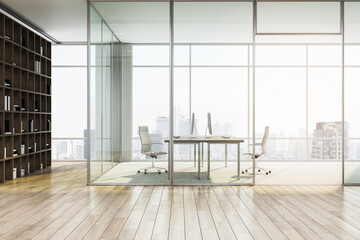 A modern office interior with glass partitions, wood flooring, and a city view in the background,...