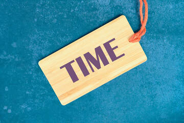 Time Concept TIME TEXT on the card on an abstract background
