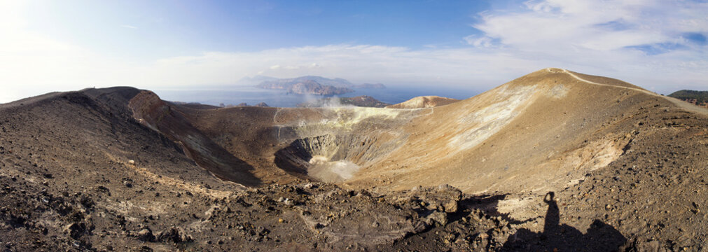 Aeolian Islands, Vulcano, Panoramic view from volcano, Gran Cratere, shadow of hiker at volcanic crater