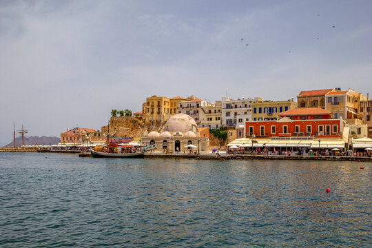 Greece, Crete, Chania, Harbor of coastal city withKucukHasanPasha Mosque in background