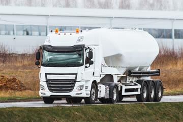 Automotive fuel tankers shipping fuel. Isothermal Tank truck driving on a highway.