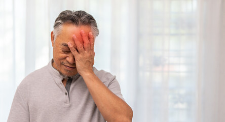 Sick unhappy senior elderly man touching head serious depressed feeling headache thinking of...