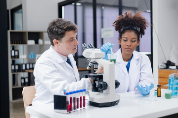 Medical science and microscope in laboratory for research concept. Two scientist with microscope...