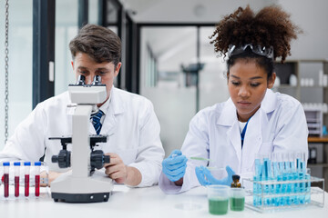 Medical science and microscope in laboratory for research concept. Two scientist with microscope...