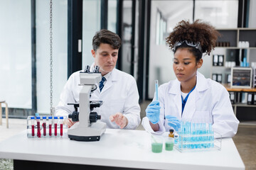 Medical science and microscope in laboratory for research concept. Two scientist with microscope...