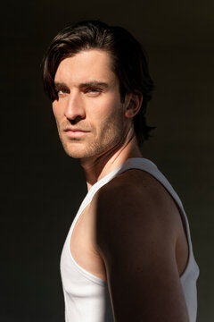 Confident young handsome man wearing undershirt under sunlight