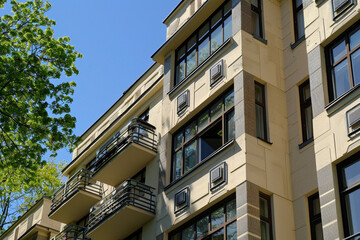 An Art Deco style apartment building with geometric motifs and sleek metal accents.