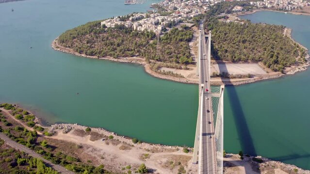 4k drone flight moving to the side footage (Ultra High Definition) of High Bridge Evripos. Amazing morning cityscape of Chalcis town, Greece. Bright seascape of Aegean sea, North Euboean Gulf.