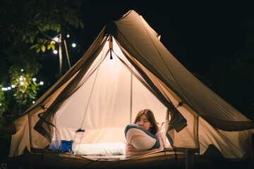 asian woman relax in camping tent on summer vacation