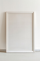 Blank white picture frame against a white wall.