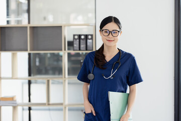 Asian female nurse holding clipboard in hospital, Healthcare and medical concept.