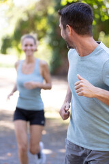 beautiful couple jogging in nature living healthy