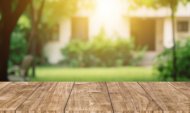 wooden table space with green home backyard view blur background for advertising template