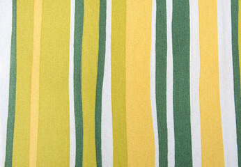 A striped fabric with yellow and green stripes. The stripes are of different widths and are...
