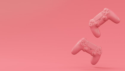 Video game joysticks or gamepads in plain monochrome pink color background