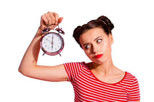 Close-up portrait of her she nice cute charming attractive glamorous sad teen girl wearing striped t-shirt holding in hand showing clock boring hour isolated over pink pastel background