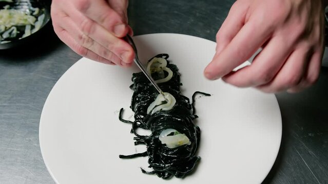 Chef Cooking Black Ink Cuttlefish Italian Spaghetti Food At Restaurant