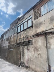 The Old buildings made of bricks and cement until the building walls turned gray under the blue sky...