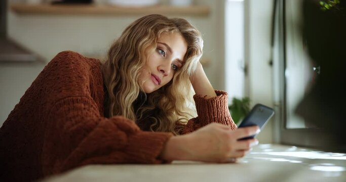 Woman, tired and depressed with smartphone in home, message or social media for browsing. Cell phone, break up or heart broken female person, stressed and mental health or grief with technology