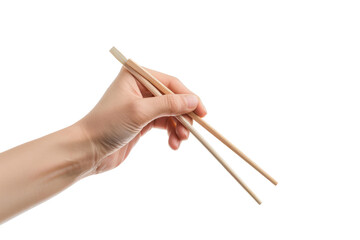A hand holding wooden chopsticks isolated on a plain background